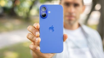 A person holding the iPhone 16 with its back facing the camera.