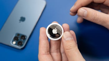 Image of an Apple Airtag held in one hand