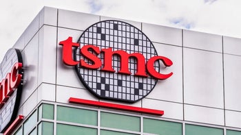 The TSMC silicon wafer logo is seen on the top of a building and the logo appears on multiple sides of the building.