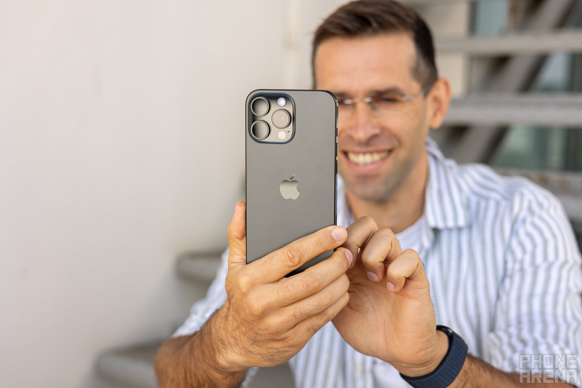 Person using the iPhone 16 Pro Max and enjoying it