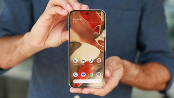 Two hands gently holding the Pixel 9 Pro XL and showing its display to the camera.