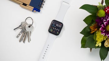 The Apple Watch Series 4 on a table next to a keychain.